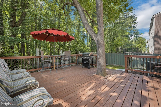 deck featuring outdoor dining space and area for grilling