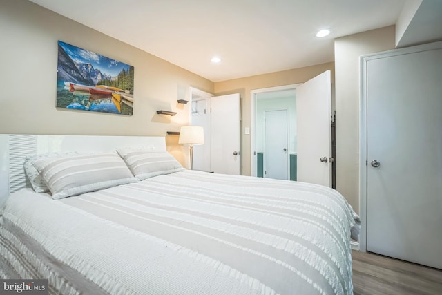 bedroom featuring recessed lighting and wood finished floors