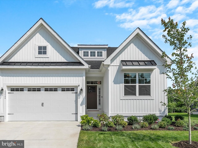 modern farmhouse with a standing seam roof, an attached garage, concrete driveway, and metal roof