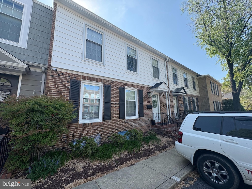 townhome / multi-family property featuring brick siding