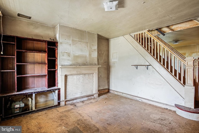 unfurnished living room with stairs