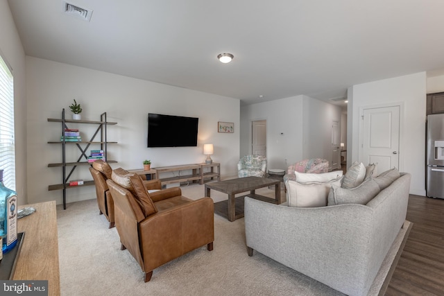 living room featuring light wood-style floors and visible vents
