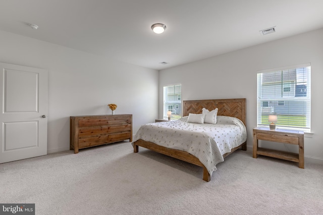 bedroom featuring visible vents, carpet flooring, and baseboards
