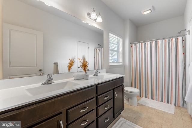 bathroom with a sink, toilet, double vanity, and a shower with shower curtain