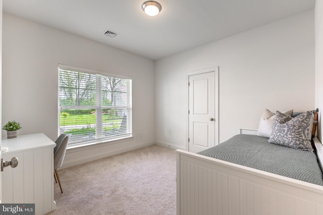 bedroom featuring baseboards and light carpet
