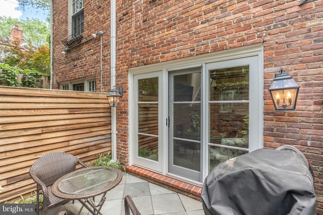 view of patio with a grill and fence