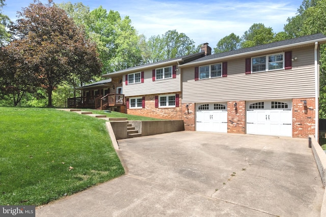 16 Tolson Ln, Stafford, VA 22556 - split level home featuring a chimney, brick siding, a front lawn, concrete driveway, and an attached garage
