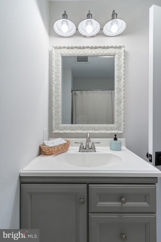 bathroom featuring visible vents and vanity