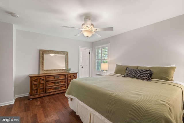 bedroom featuring dark wood-type flooring, baseboards, and ceiling fan