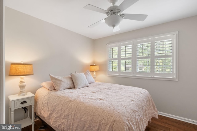 bedroom with baseboards, ceiling fan, and wood finished floors