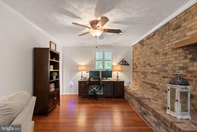 office with ceiling fan, brick wall, a textured ceiling, visible vents, and hardwood / wood-style flooring