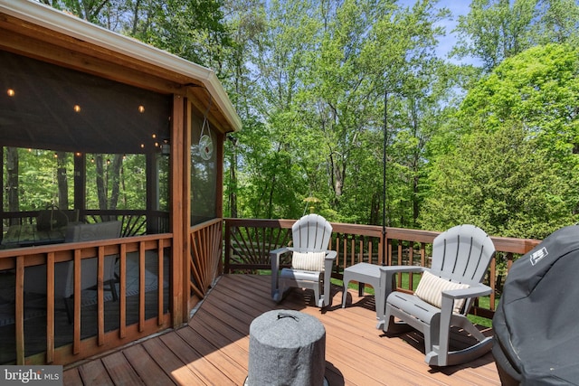 wooden terrace featuring a grill