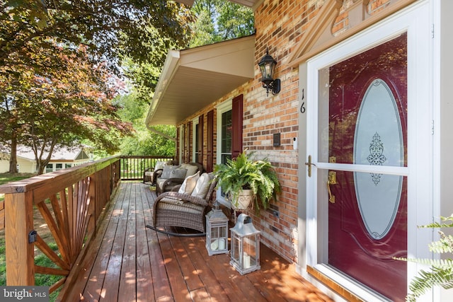 wooden deck with an outdoor living space