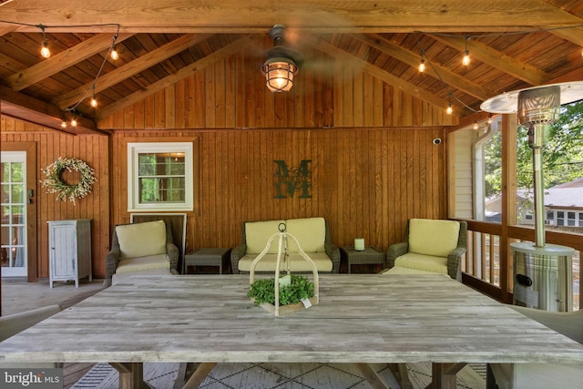 sunroom featuring beamed ceiling and rail lighting