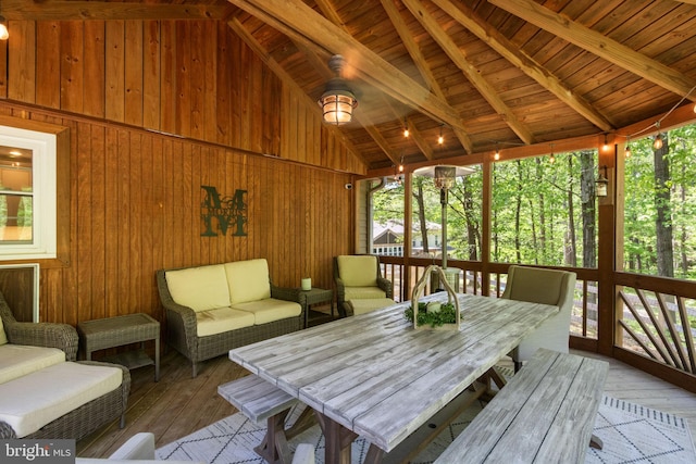 sunroom with an outdoor living space, beamed ceiling, and a healthy amount of sunlight