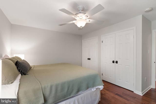 bedroom with a ceiling fan, baseboards, and dark wood-type flooring