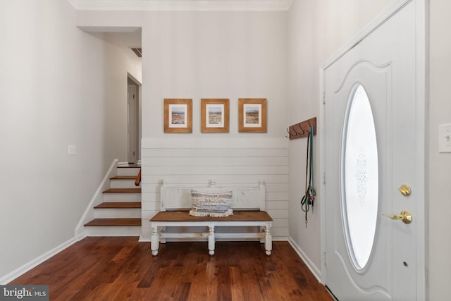 entrance foyer with baseboards, stairs, wood finished floors, and visible vents