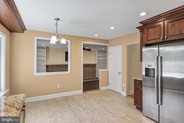 kitchen with light stone counters, recessed lighting, baseboards, stainless steel refrigerator with ice dispenser, and pendant lighting