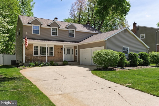 traditional-style home with a garage, a front lawn, fence, and concrete driveway