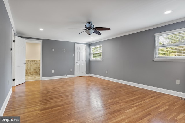 empty room featuring ceiling fan, ornamental molding, baseboards, and light wood-type flooring
