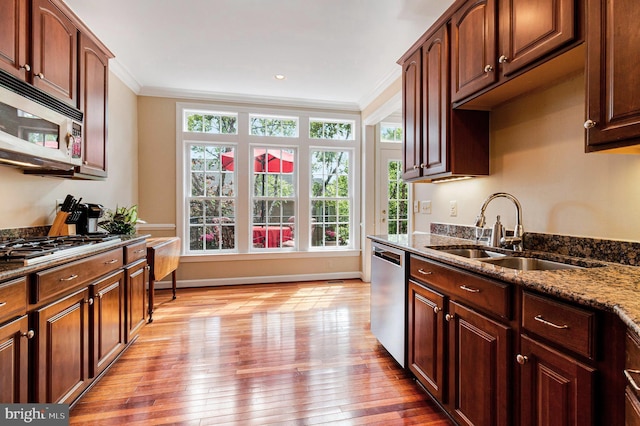 6531 Washington Blvd, Arlington, VA 22205 - kitchen with appliances with stainless steel finishes, a sink, crown molding, dark stone counters, and light wood-type flooring