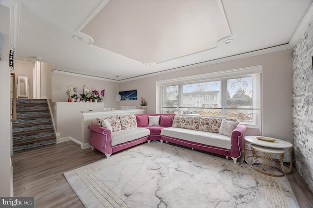 living area with stairway, ornamental molding, and wood finished floors