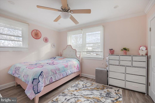 bedroom featuring baseboards, ornamental molding, and wood finished floors