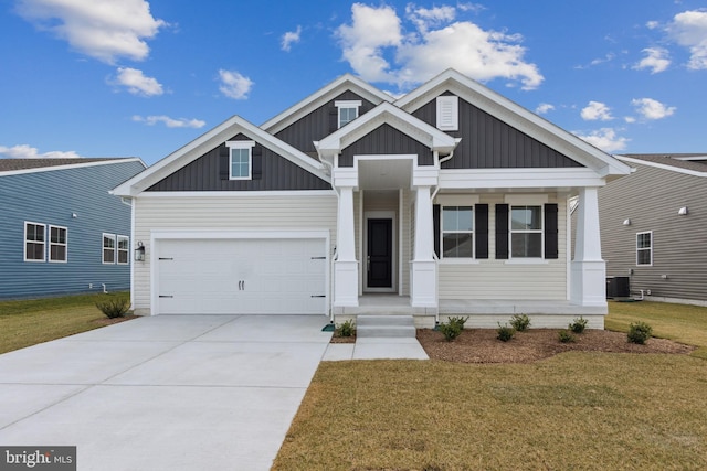 craftsman-style home with board and batten siding, a front yard, central AC unit, a garage, and concrete driveway