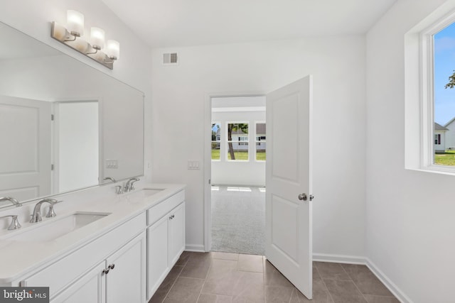 bathroom with a sink, tile patterned flooring, and visible vents