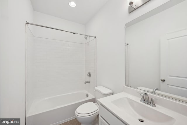 bathroom featuring recessed lighting, vanity, bathtub / shower combination, and toilet