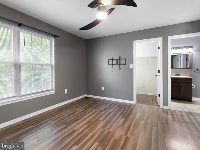 34 Dovetree Dr, Newark, DE 19713 - unfurnished bedroom with dark wood-type flooring, a spacious closet, baseboards, a closet, and ensuite bath