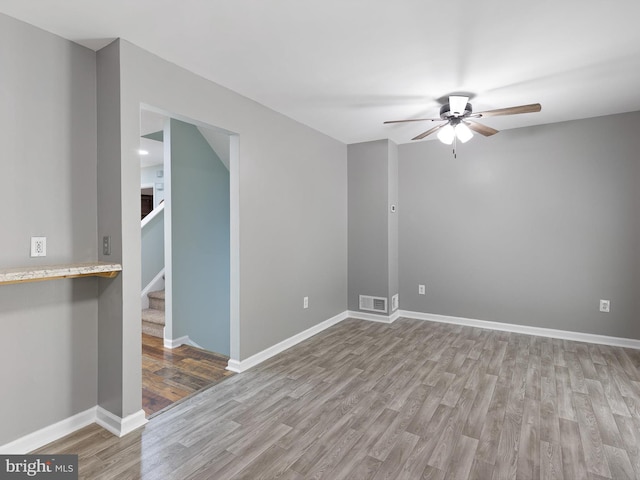 34 Dovetree Dr, Newark, DE 19713 - unfurnished room featuring ceiling fan, wood finished floors, stairway, and baseboards