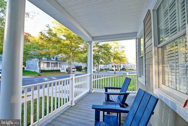 wooden terrace with covered porch and a residential view