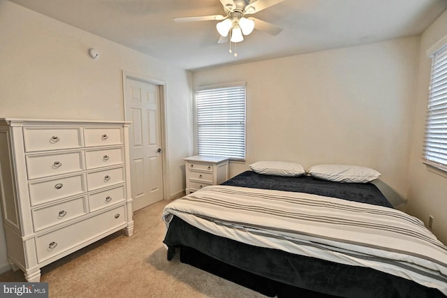 bedroom with ceiling fan and light colored carpet