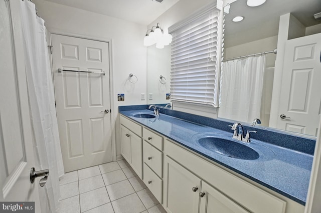 full bath with tile patterned flooring, a sink, and double vanity