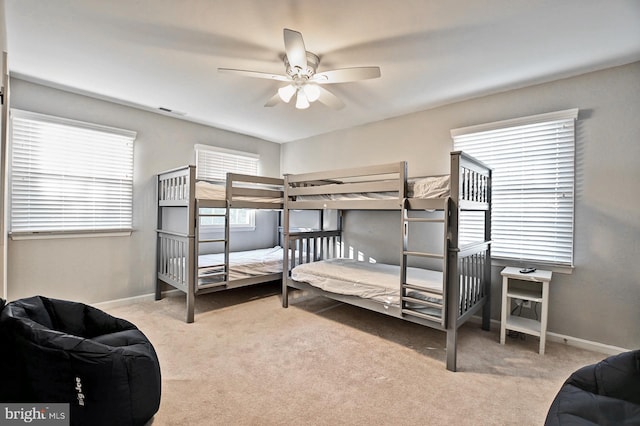 carpeted bedroom with baseboards and visible vents