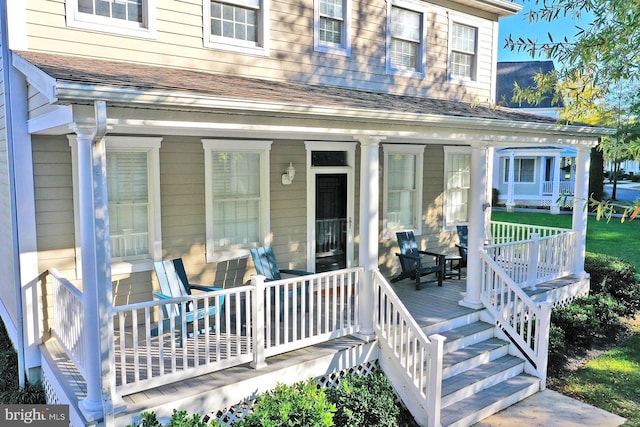 exterior space featuring a porch and a shingled roof