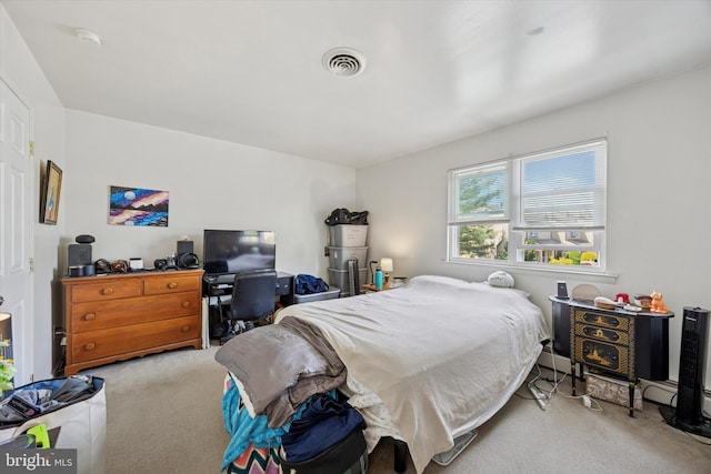 carpeted bedroom featuring visible vents