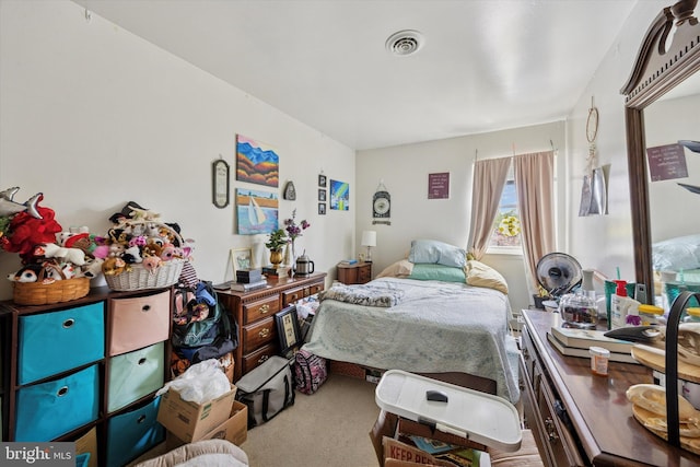carpeted bedroom featuring visible vents