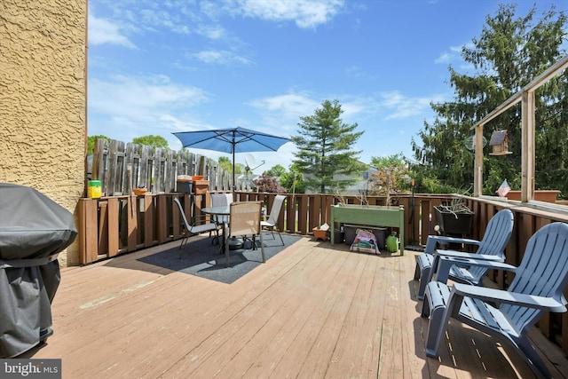 deck with area for grilling and outdoor dining space