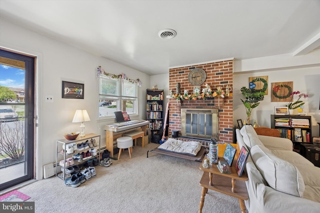 living area featuring visible vents, carpet, and a fireplace