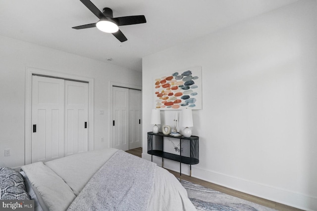 2524 41st St NW Unit 1, Washington, DC 20007 - bedroom featuring a ceiling fan, baseboards, multiple closets, and wood finished floors