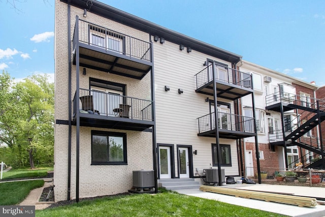2524 41st St NW Unit 1, Washington, DC 20007 - rear view of house with brick siding, central AC, and a balcony
