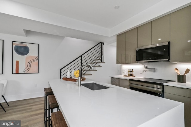 2524 41st St NW Unit 1, Washington, DC 20007 - bar with a sink, wall oven, baseboards, wood finished floors, and stairway