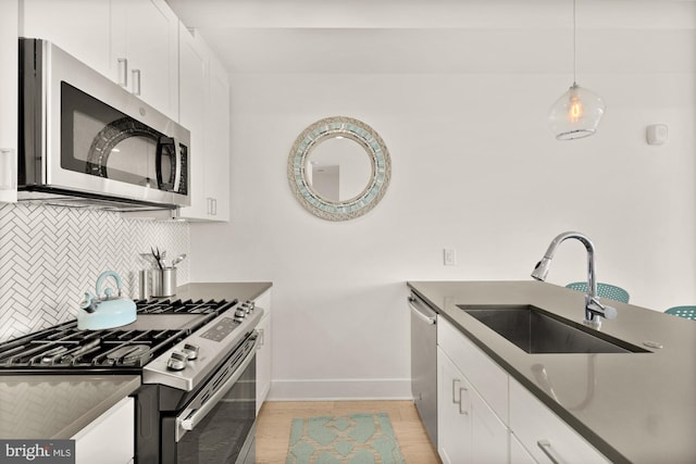 4016 Georgia Ave NW Unit 9, Washington, DC 20011 - kitchen featuring decorative backsplash, appliances with stainless steel finishes, dark countertops, a sink, and baseboards