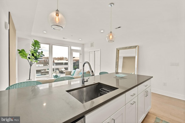 4016 Georgia Ave NW Unit 9, Washington, DC 20011 - kitchen featuring a sink, decorative light fixtures, white cabinetry, and visible vents