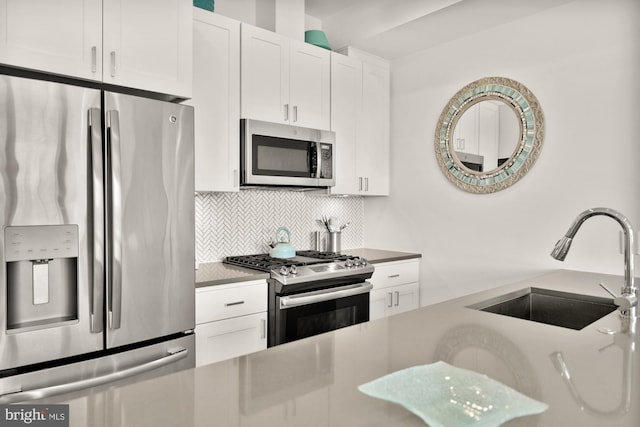 4016 Georgia Ave NW Unit 9, Washington, DC 20011 - kitchen with white cabinetry, appliances with stainless steel finishes, decorative backsplash, and a sink