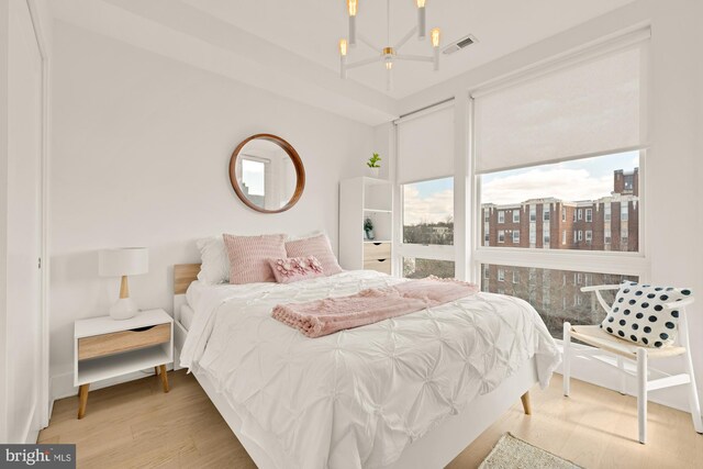 4016 Georgia Ave NW Unit 9, Washington, DC 20011 - bedroom with an inviting chandelier, wood finished floors, and visible vents