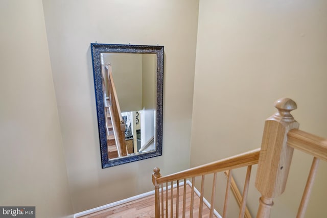 stairway featuring baseboards and wood finished floors