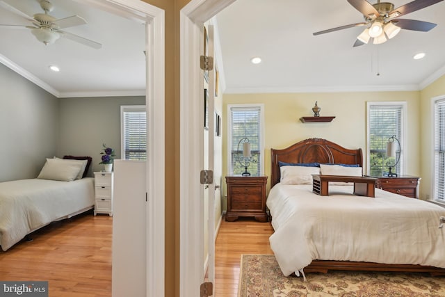 bedroom with light wood-style floors, ornamental molding, recessed lighting, and multiple windows